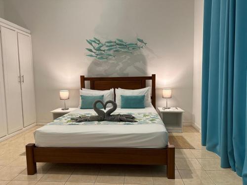 a bedroom with a bed with a pair of scissors on it at Korail Bleu in Rodrigues Island