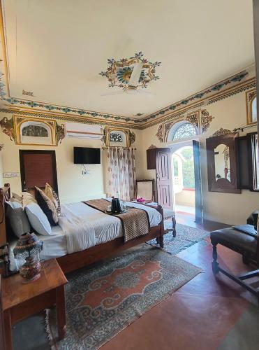 a bedroom with a large bed in a room at Raj Haveli- A Heritage Samode in Jaipur
