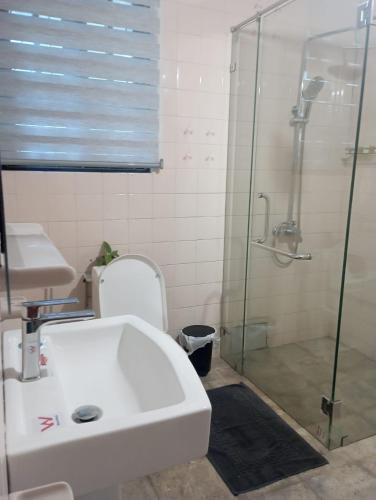 a bathroom with a sink and a glass shower at Country Homes Srilanka in Mount Lavinia