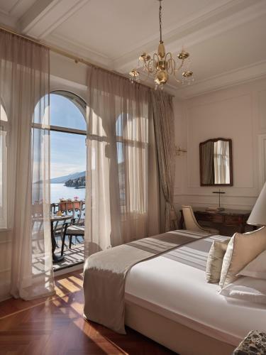 a bedroom with a large bed and a large window at Amadria Park Hotel Milenij in Opatija