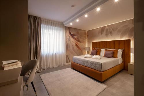 a bedroom with a bed and a desk with a desk at Giorgio Raggi Hospitality in Terni