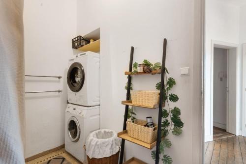 a laundry room with a washer and dryer at Cozy Antwerp - Sunny Zurenborg in Antwerp