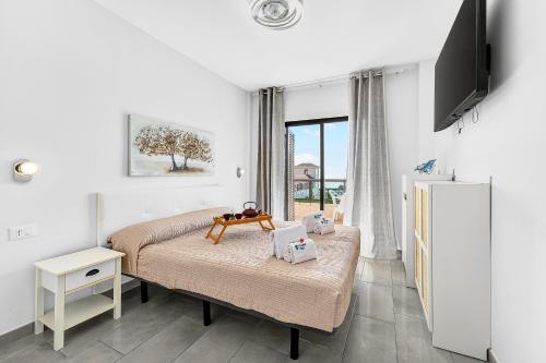 a bedroom with a bed with a table on it at Atlantic Penthouse Retreat in Costa Del Silencio