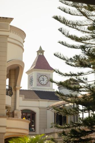 a building with a clock tower on top of it at Erawan Phangnga Hotel, Natai Beach in Ban Na Phong