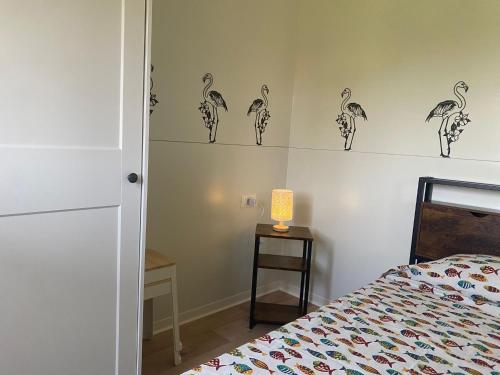 a bedroom with a bed and a lamp on a table at MH Oasi in Stazione di Albinia