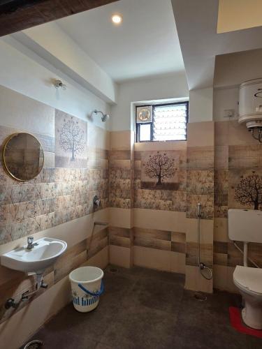 a bathroom with a sink and a toilet at Ghare Stays Udaipur in Udaipur