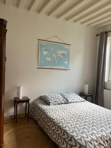 a bedroom with a bed and a map on the wall at LE PETIT MATELOT in Honfleur