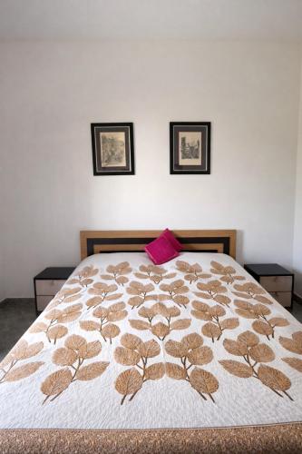 a bedroom with a bed with a brown and white blanket at Ghare Stays Udaipur in Udaipur