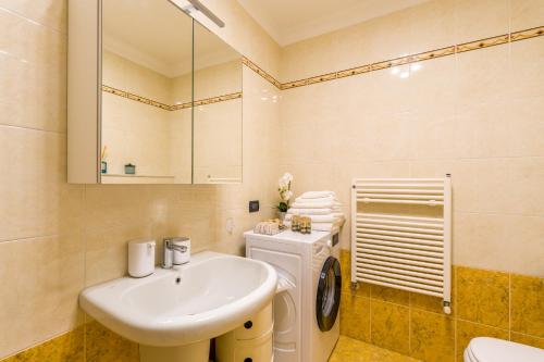 a bathroom with a sink and a washing machine at Suite Des Etrangers -Parcheggio privato- Private parking in Sanremo