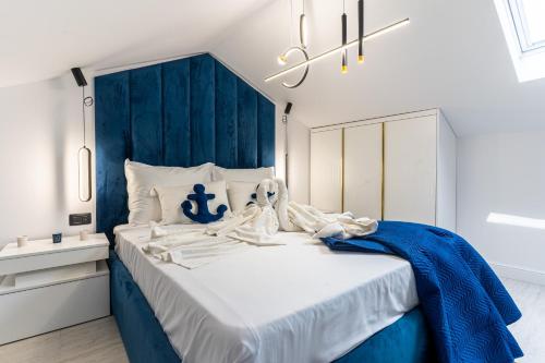 a blue and white bedroom with a large bed at Vila Inar Cres in Cres