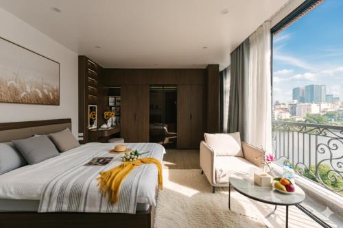 a bedroom with a king sized bed and a balcony at Chic & Stylist Studio Lakeview in Hanoi
