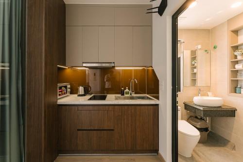 a small bathroom with a sink and a toilet at Chic & Stylist Studio Lakeview in Hanoi