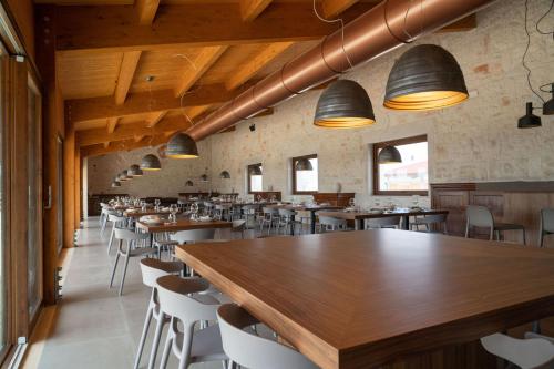 a dining room with wooden tables and chairs at DONNAPAOLA MODERN FARM in Altamura