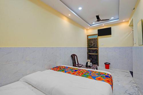 a bedroom with a bed and a television in it at Via Shree Gopal Inn in Varanasi