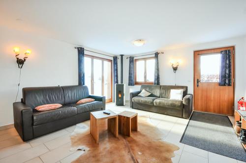 a living room with a couch and a table at FeWo im Chalet Schneeflöckli in La Tzoumaz