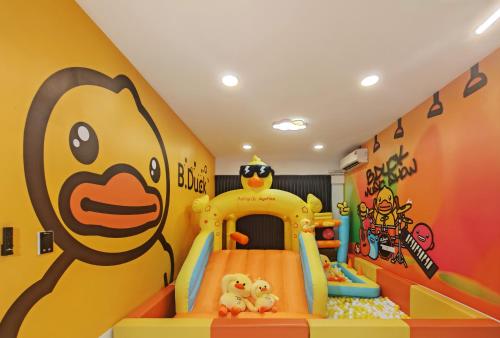 a childs play room with a yellow and orange wall at Naughty Castle Playground & Ball Pool in Johor Bahru