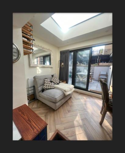 a living room with a couch and a table at Spacious House In Guildford in Stoughton