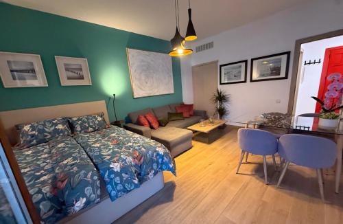 a bedroom with a bed and a living room at La Roca Sea View Luxury Apartment Beach Elevator in Torremolinos
