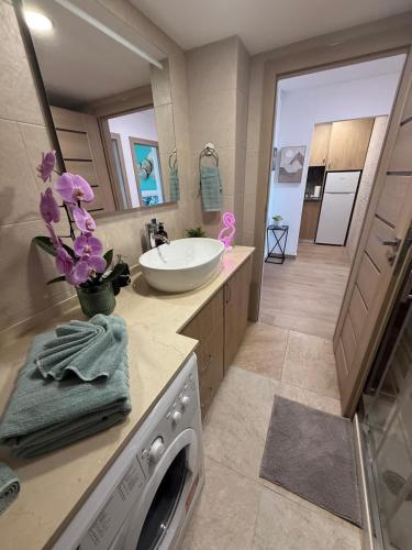 a bathroom with a sink and a washing machine at La Roca Sea View Luxury Apartment Beach Elevator in Torremolinos