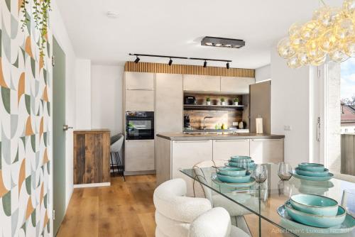 a dining room and kitchen with a glass table and chairs at Bad Aibling Apartments in Bad Aibling