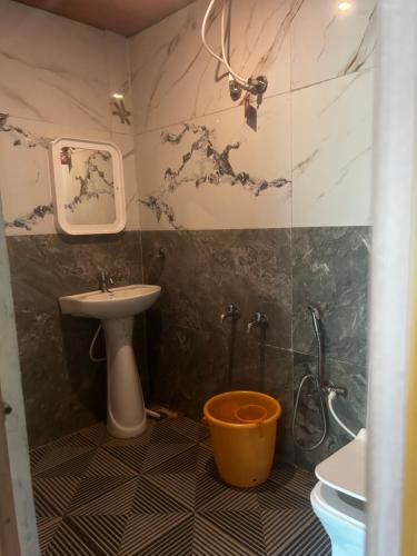 a bathroom with a sink and a shower at Coorg Sana Riverside in Suntikoppa