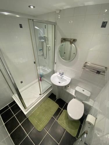 a bathroom with a shower and a toilet and a sink at Home in Cwmbran with free onsite parking in Cwm-brân