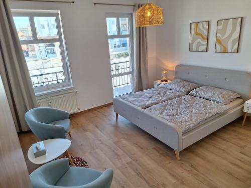 a bedroom with a bed and a table and chairs at Apartmán Stará Tržnica in Trenčín