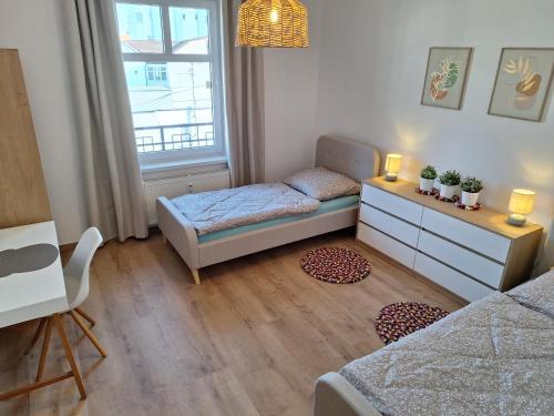 a small room with a bed and a desk at Apartmán Stará Tržnica in Trenčín