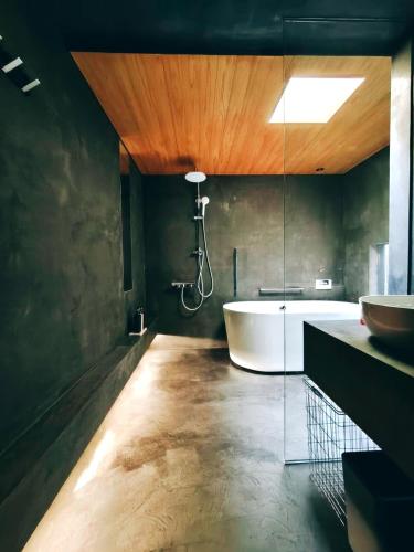 a bathroom with a bath tub and a sink at Luna House KIYOMIZU 一棟貸し 月上 清水 in Kyoto