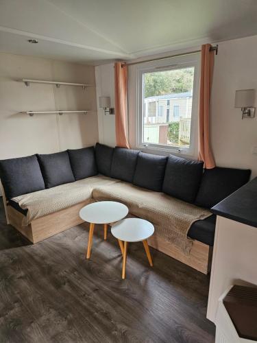 un salon avec un canapé et deux tables dans l'établissement 403 La Pignade, à La Tremblade