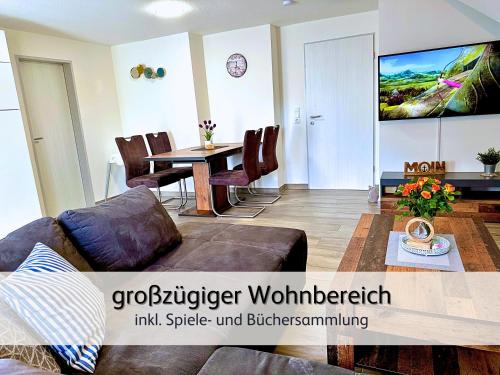 a living room with a couch and a table at strandnahe Familien-Oase mit Kinderbuggy in Bensersiel