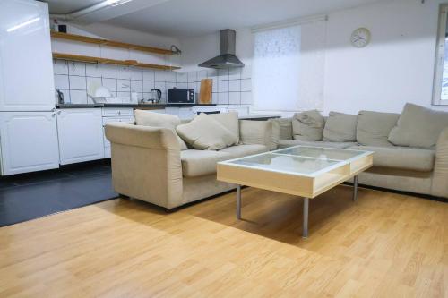 a living room with a couch and a coffee table at Workers Stay - Staff Accommodation Säve - Göteborg in Säve