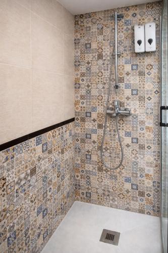 a bathroom with a shower with tiles on the wall at Sentir CAZORLA in Cazorla