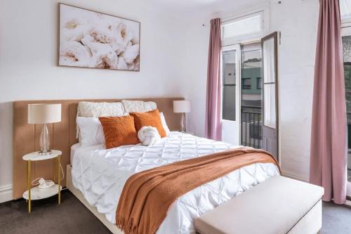 a bedroom with a large bed and a window at 3BR CBD Aircon Redfern family home in Sydney