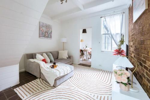 a living room with a couch and a rug at 3BR CBD Aircon Redfern family home in Sydney
