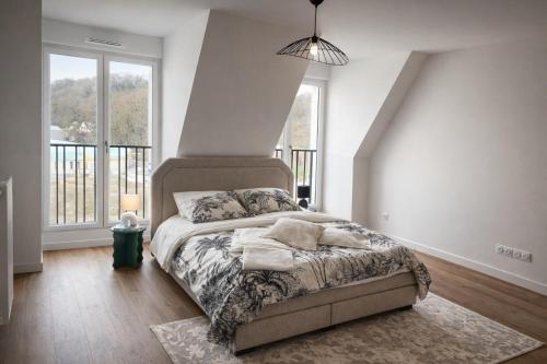a bedroom with a bed and a large window at Cocon Seine parisii in Sartrouville