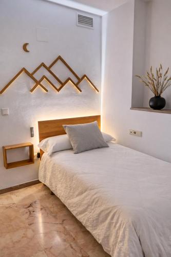 a bedroom with a large bed in a white room at Sentir CAZORLA in Cazorla