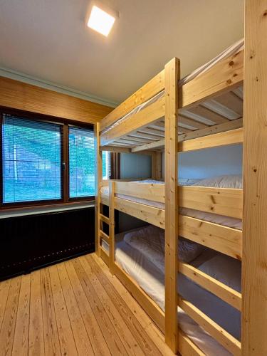 a room with two bunk beds in a cabin at Villa Bonheur in Koksijde