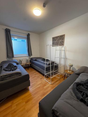 a living room with two beds and a bunk bed at Linz Wasserwald - cozy 2BR Apartment in Linz