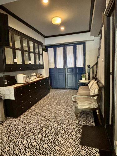 a bathroom with blue doors and a room with a floor at Maison Dang Boutique Hotel in Chiang Mai