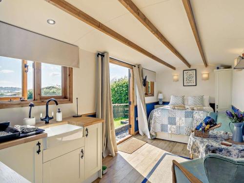 a kitchen and a bedroom with a bed and a window at 1 Bed in Cheltenham oc-95422 in Cheltenham