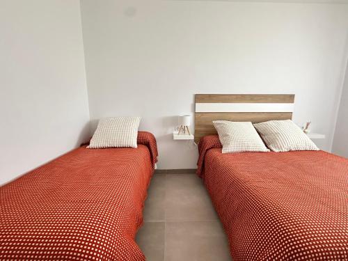 two beds sitting next to each other in a bedroom at Chalet Chiclana in Chiclana de la Frontera