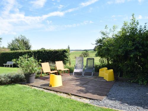 a group of chairs sitting on a wooden deck at Libramont Stone Garden Haven in Libramont