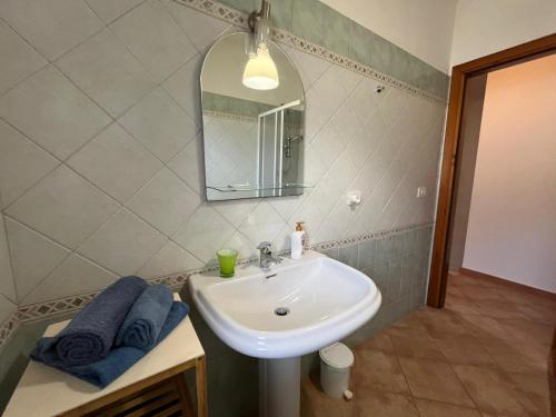 a bathroom with a sink and a mirror at Casa FLORE in Orosei
