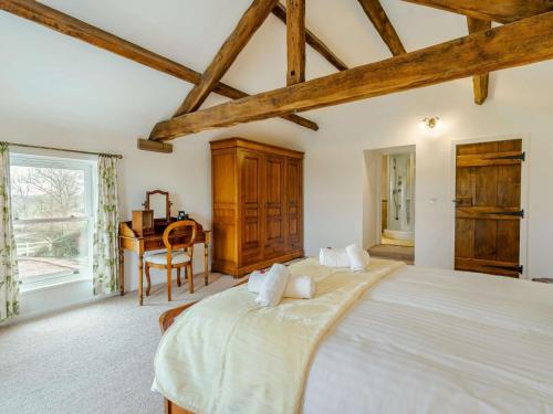 a large bedroom with a large bed and a desk at 4 Bed in Wigton oc-79563 in Calvo
