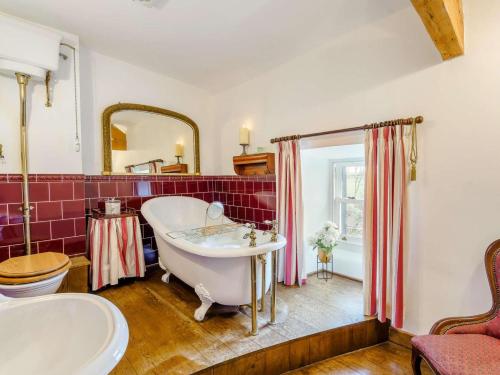 a bathroom with a tub and a sink at 4 Bed in Wigton oc-79563 in Calvo