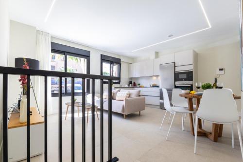 a kitchen and living room with a table and chairs at Brisamar Suites I by VillaGranCanaria in Arinaga