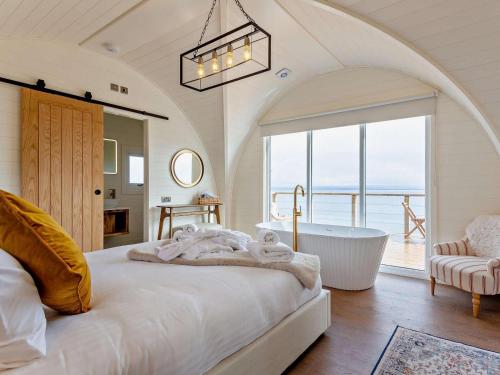 a bedroom with a large bed and a bath tub at 1 Bed in Tain oc-96065 in Nigg