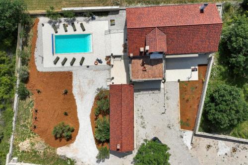 an aerial view of a house with a swimming pool at Demare in Gospić