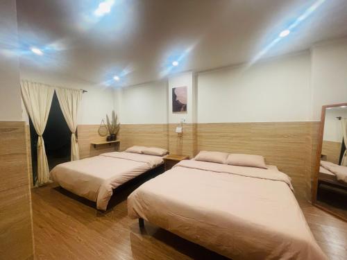 a room with two beds in a room at Homestay 234 Dốc Lết in Ba Ha